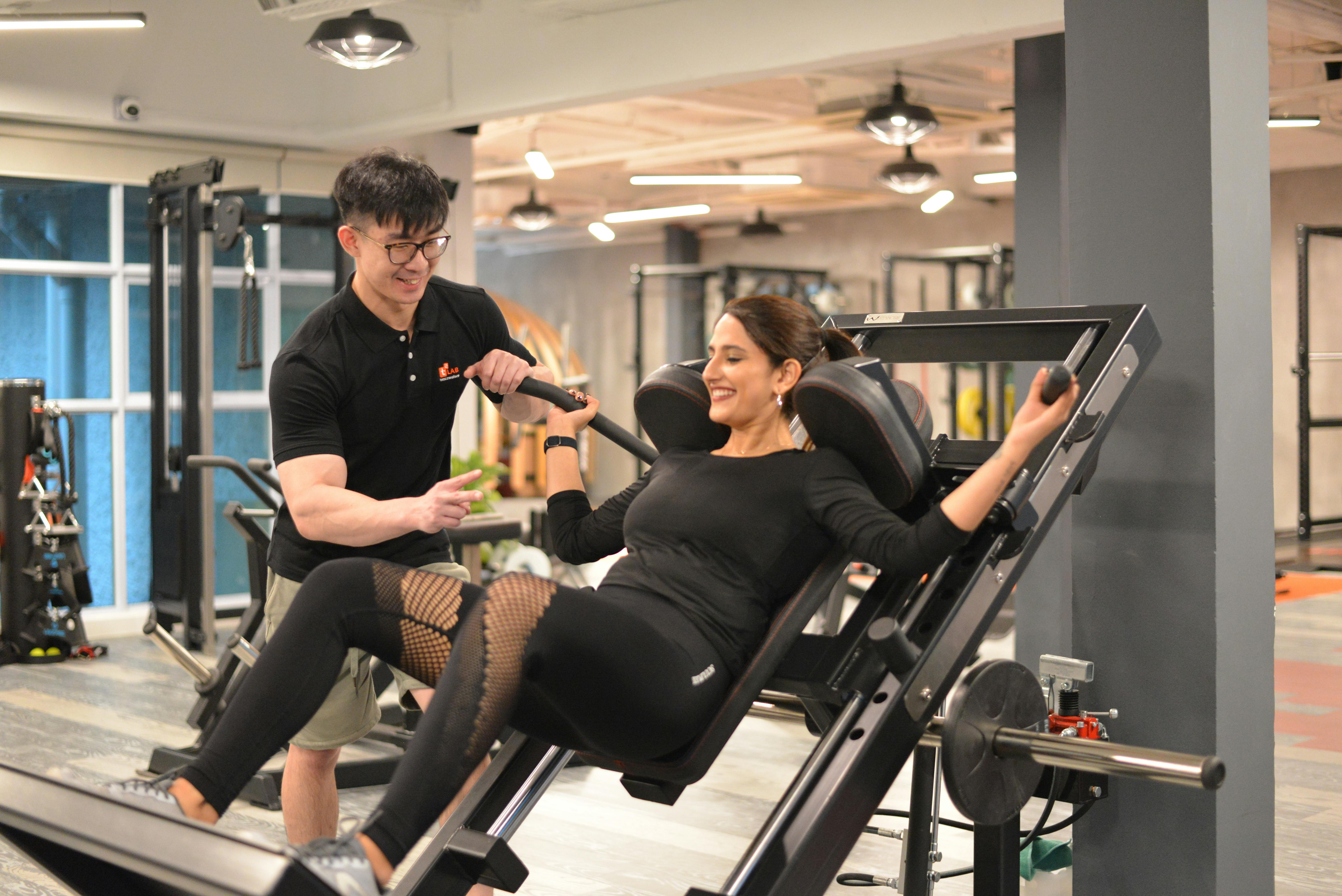 Personal trainer helping client